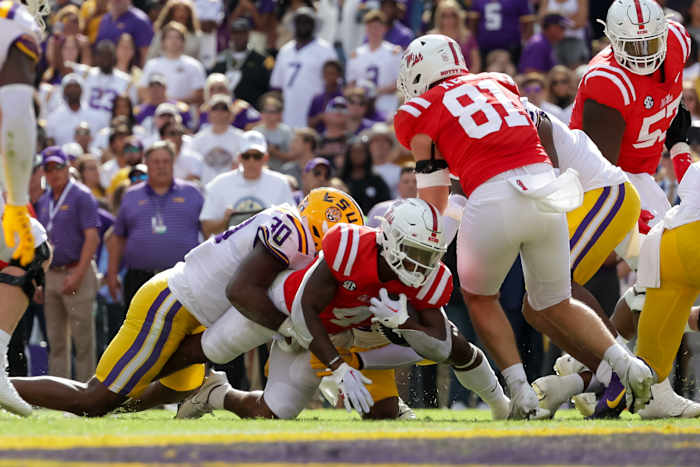 Oct 22, 2022; Baton Rouge, Louisiana, USA; Mississippi Rebels running back Quinshon Judkins (4) rushes in for a touchdown against LSU Tigers linebacker Greg Penn III (30) during the first half at Tiger Stadium. Mandatory Credit: Stephen Lew-USA TODAY Sports